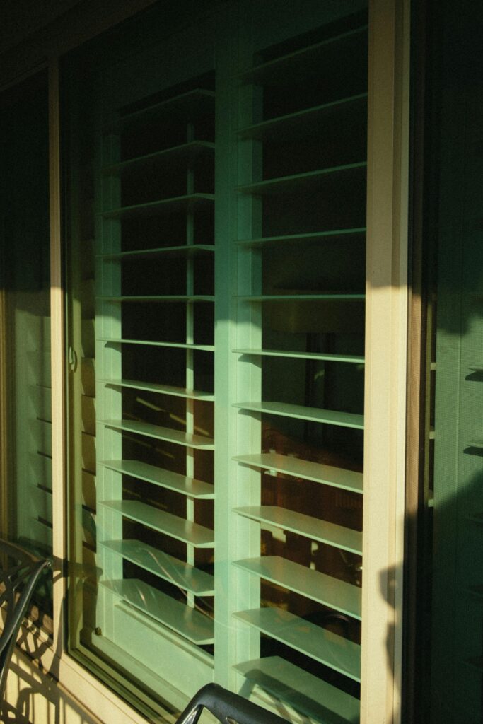 A bright interior featuring a window with open blinds, showcasing modern interior design in Delhi.