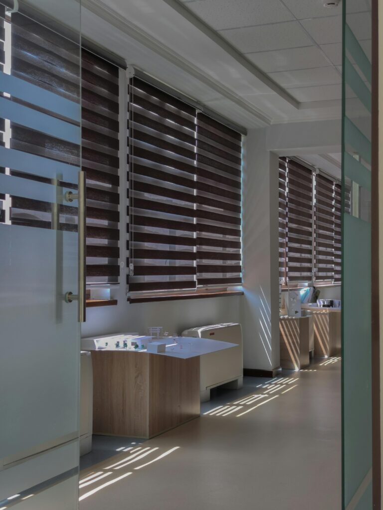 A well-designed hallway with wooden blinds and a window, reflecting contemporary interior design in Delhi.